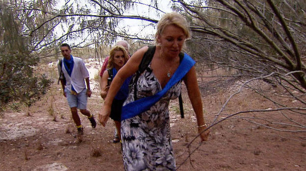Nadine Dorries, Colin Baker, Eric Bristow, Hugo Taylor and Ashley Roberts wade across an island.