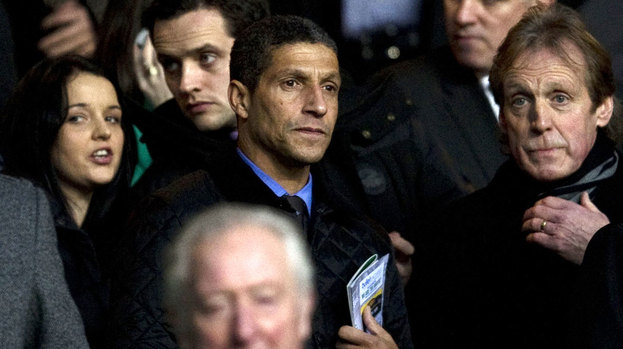 Norwich manager Chris Hughton takes his place in the stand.