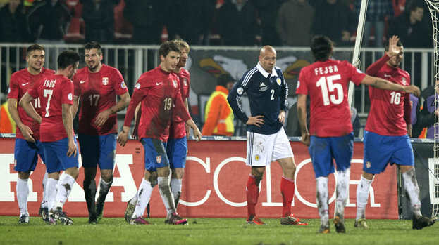 Scotland's Alan Hutton (centre) and Grant Hanley (right) look on as Filip Duricic (19) celebrates his second goal of the night with his team-mates