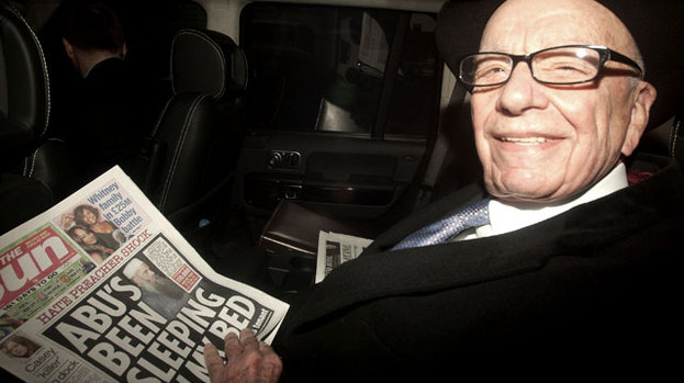 Paper man: Rupert Murdoch out and about with a copy of his paper The Sun