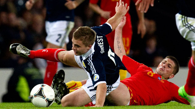 Scotland's James Forrest (left) is clipped by Veliche Shumulikoski.